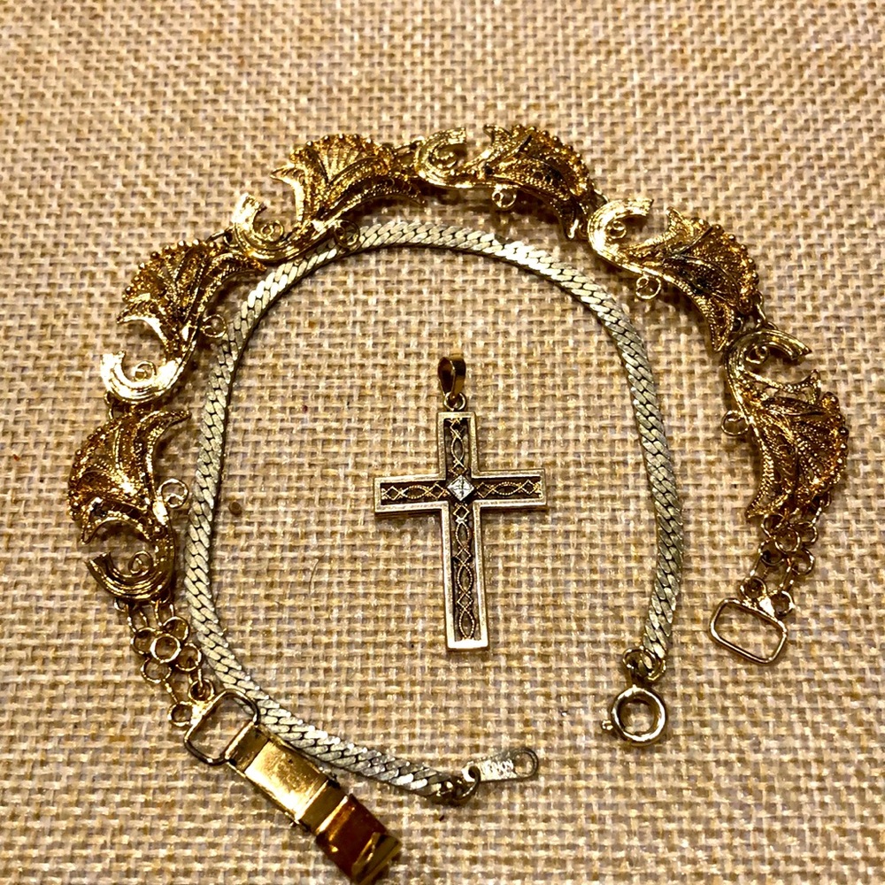 2 gold tone bracelets and gold tone cross pendant